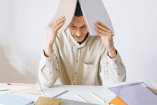 Man overwhelmed with paperwork