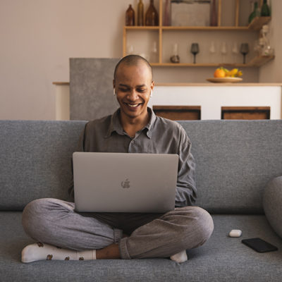 man smiling at laptop