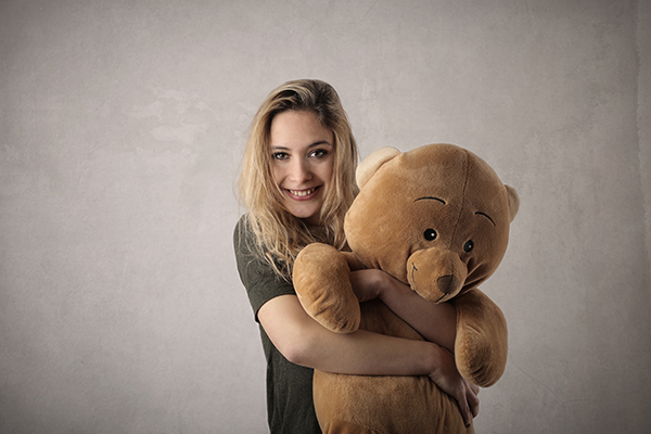 woman with large teddy bear toy